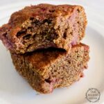 einkorn blondies stacked on a plate with a bite out of the top one