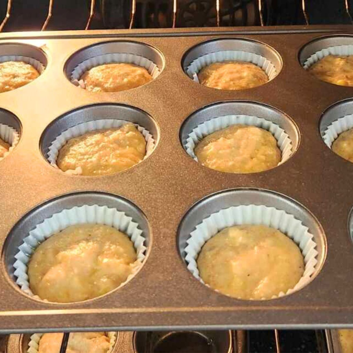 raw muffins being placed in the oven