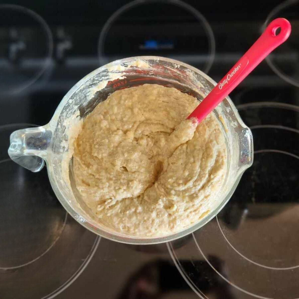 muffin batter mixed up in a large measuring glass