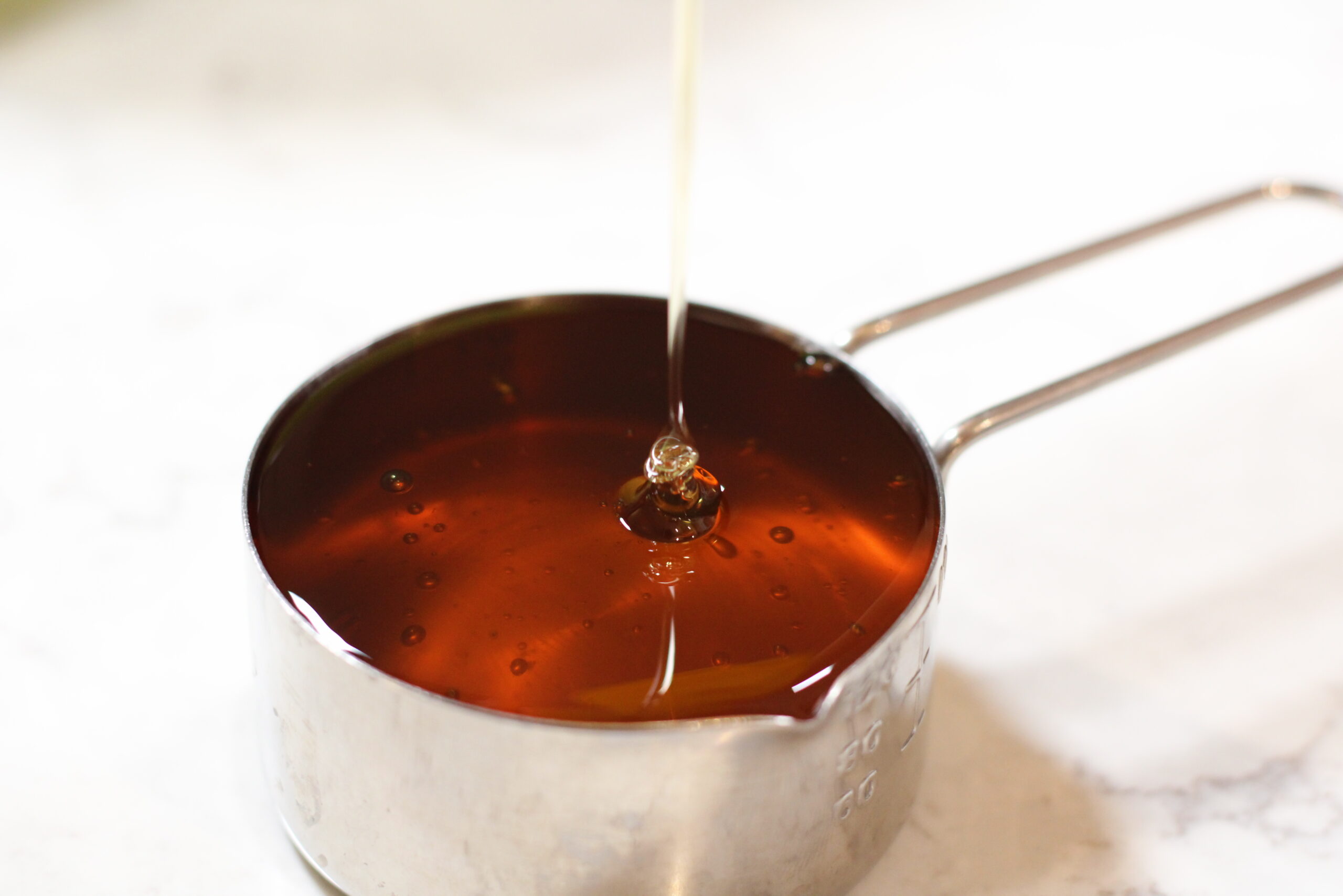 honey in a measuring cup