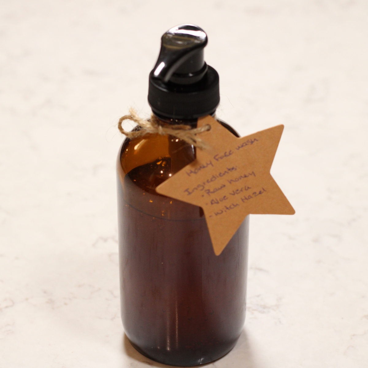 glass pump bottle with star shaped label tied to it