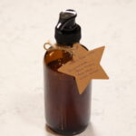 glass pump bottle with star shaped label tied to it