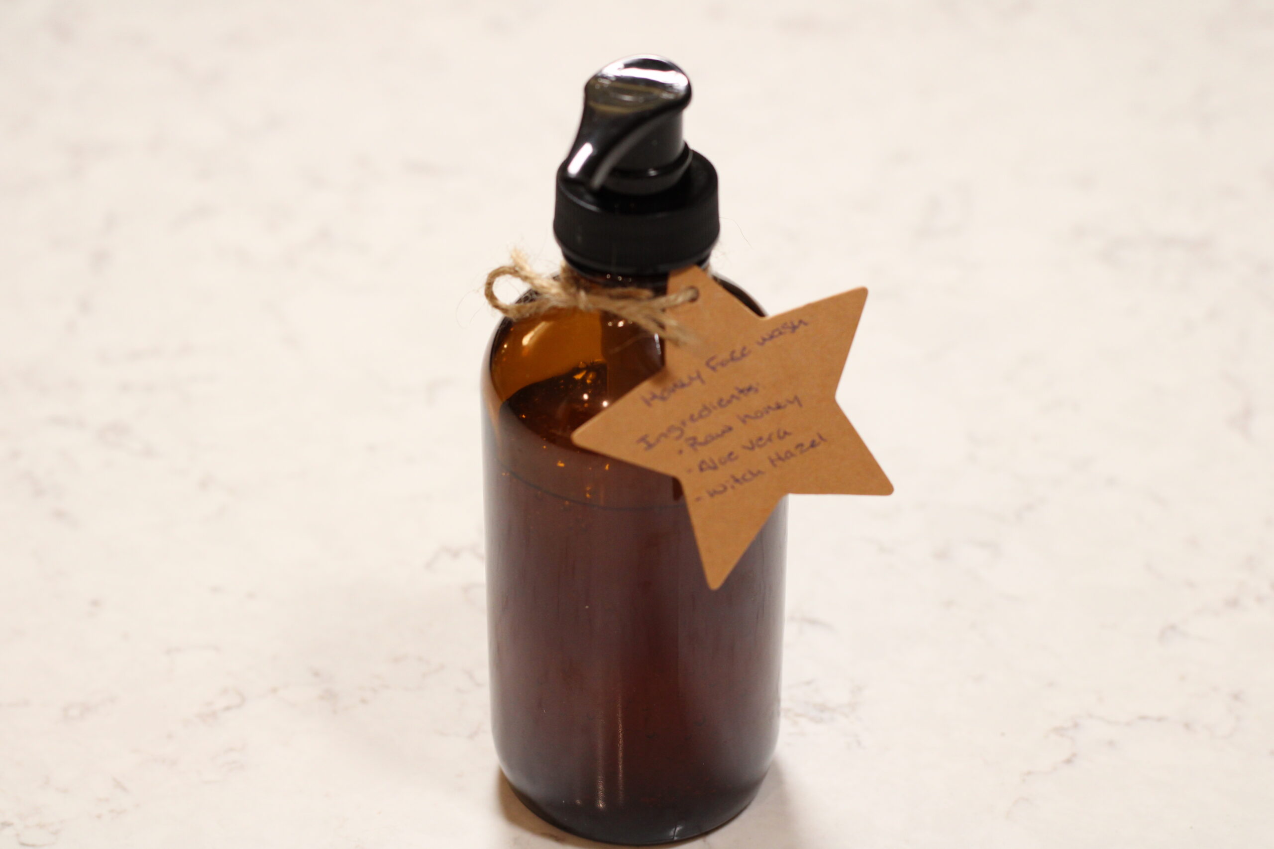 glass pump bottle with star shaped label tied to it