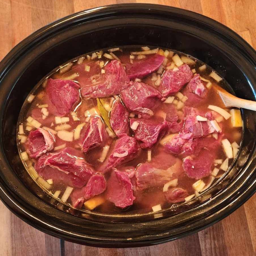 beef and broth in a slow cooker