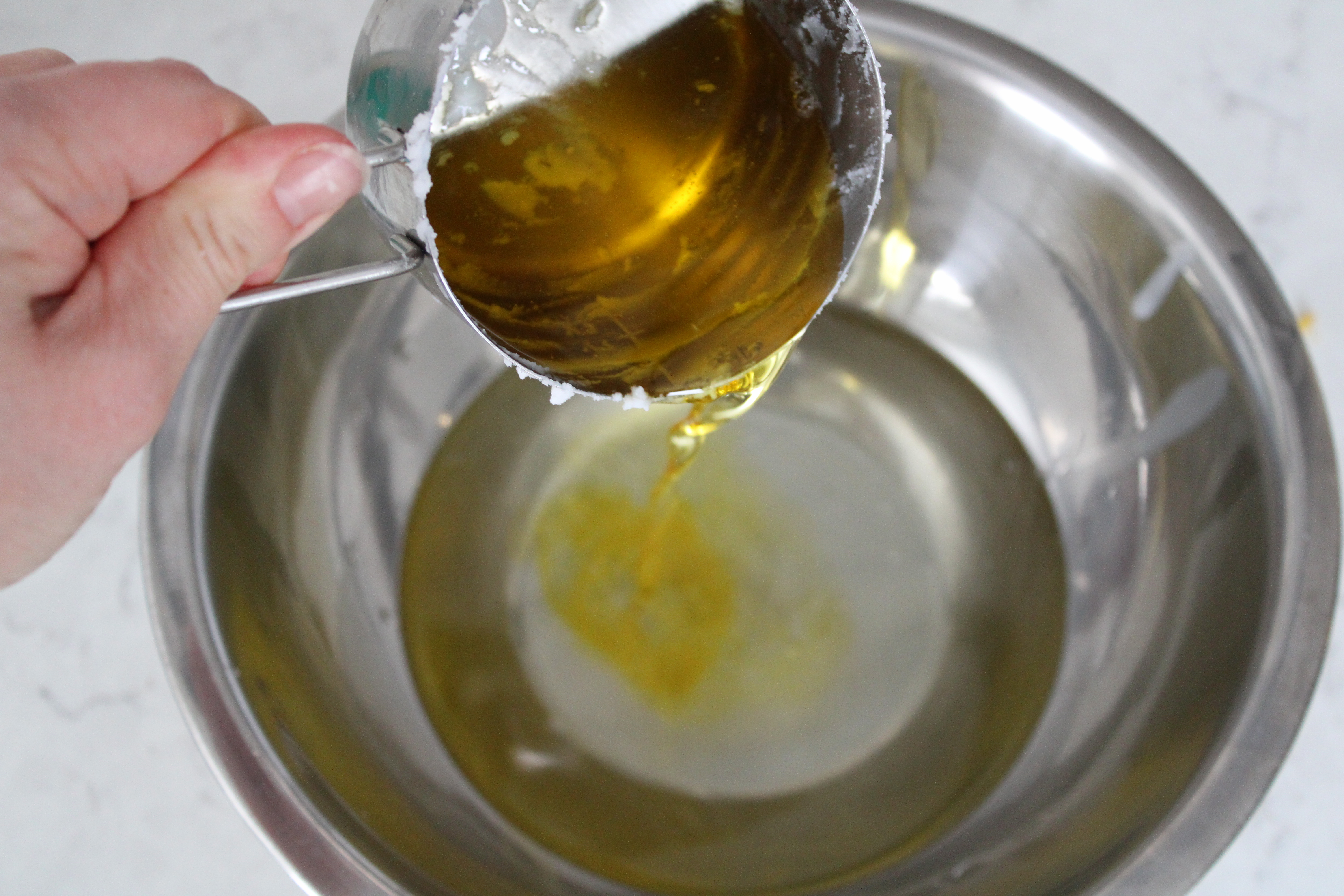 oil being poured into melted tallow