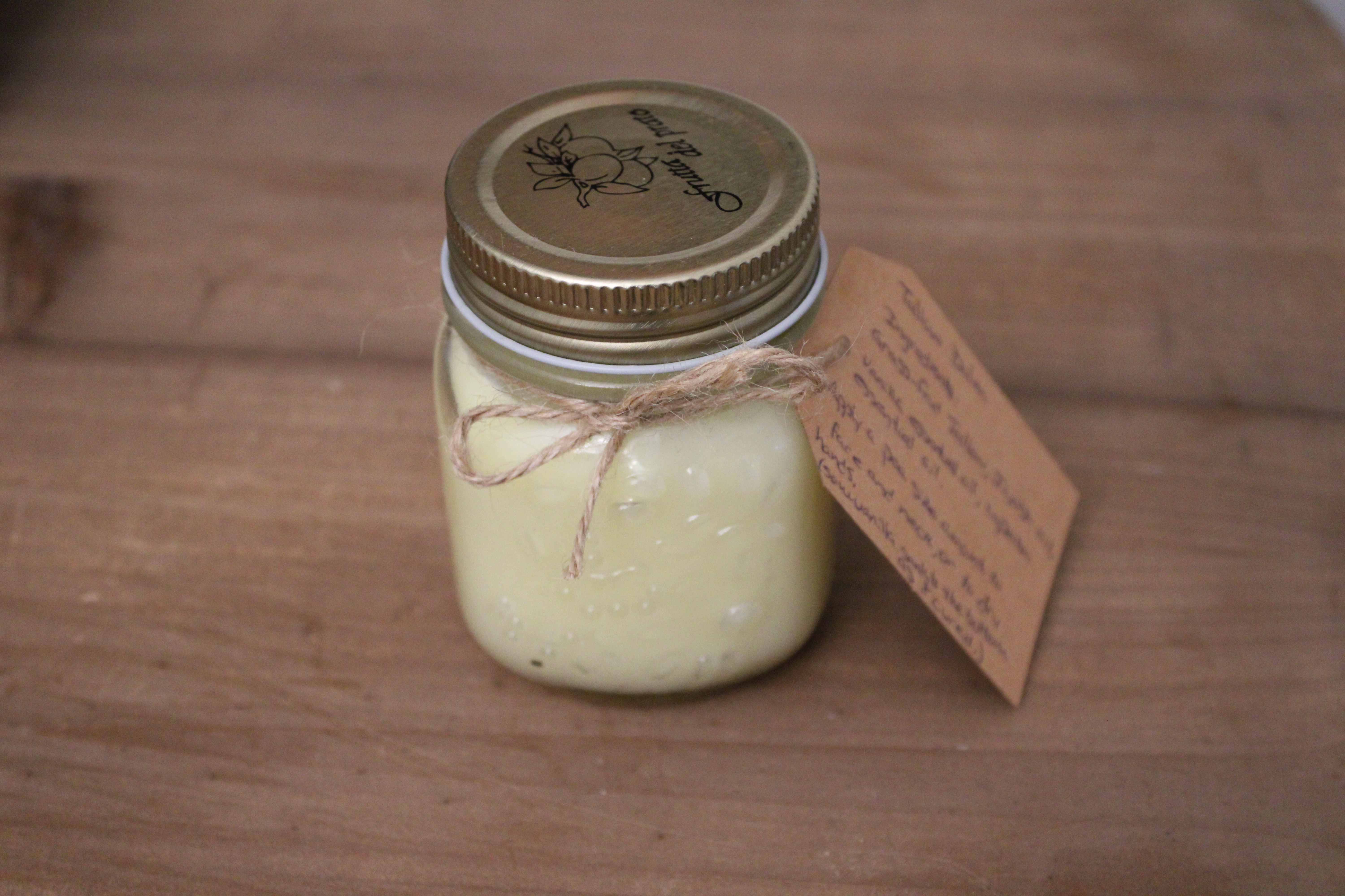 jar of tallow balm with a label tied to it with twine