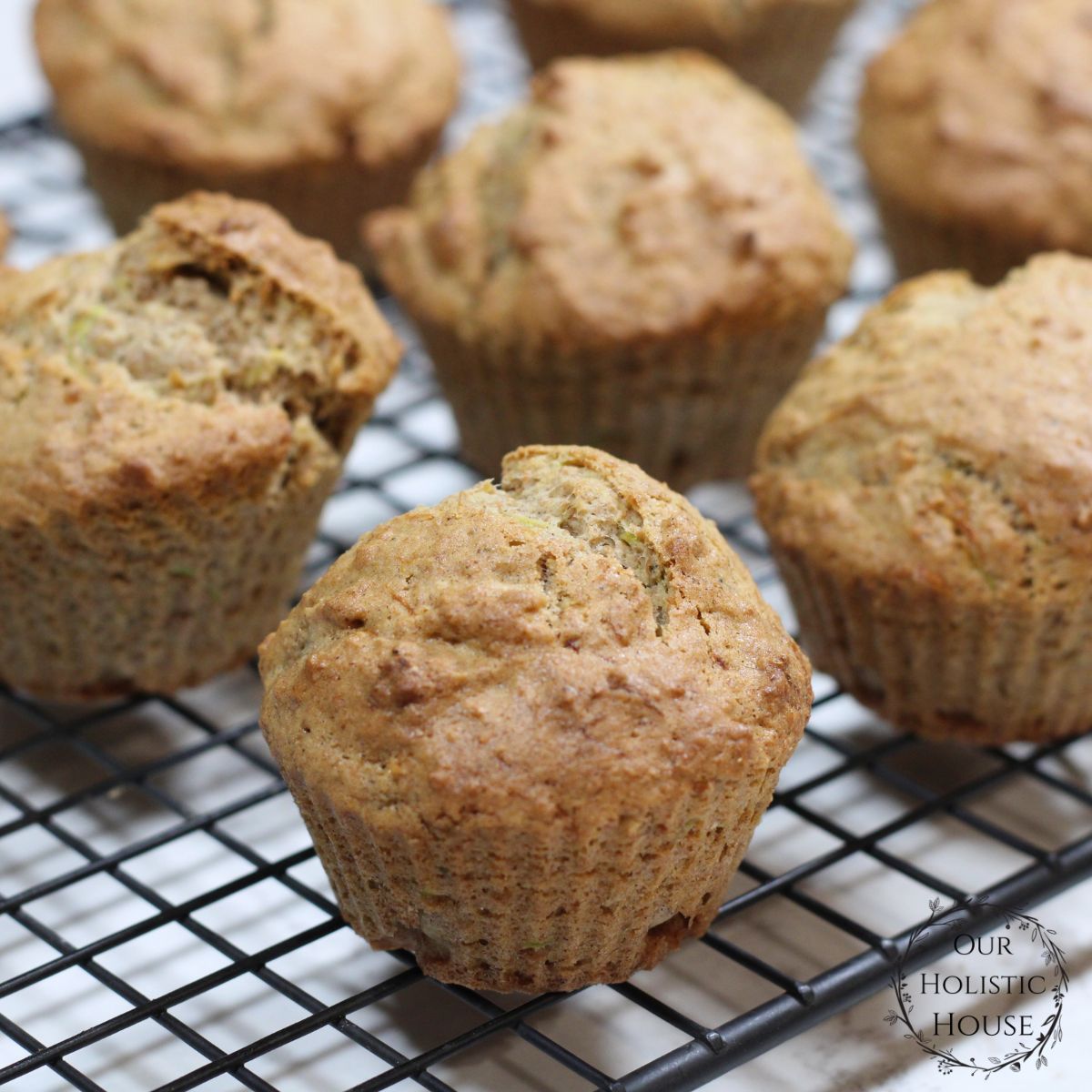 close up of zucchini muffins on a wire rack