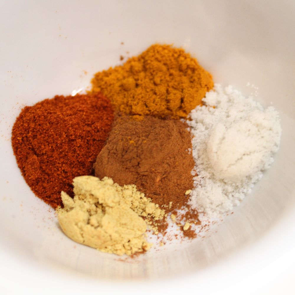 spices in a bowl together, in individual piles, not yet mixed