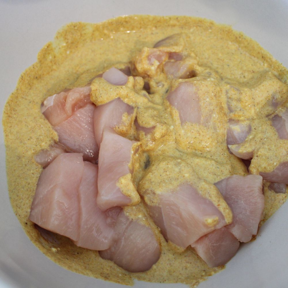 raw chicken pieces in marinade