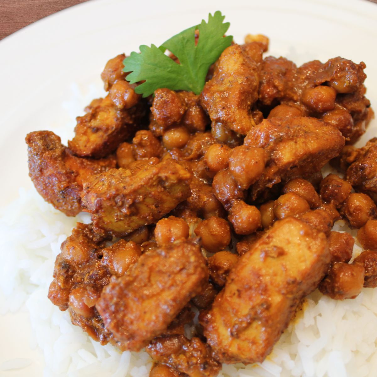 close up of butter chicken on a bed of rice