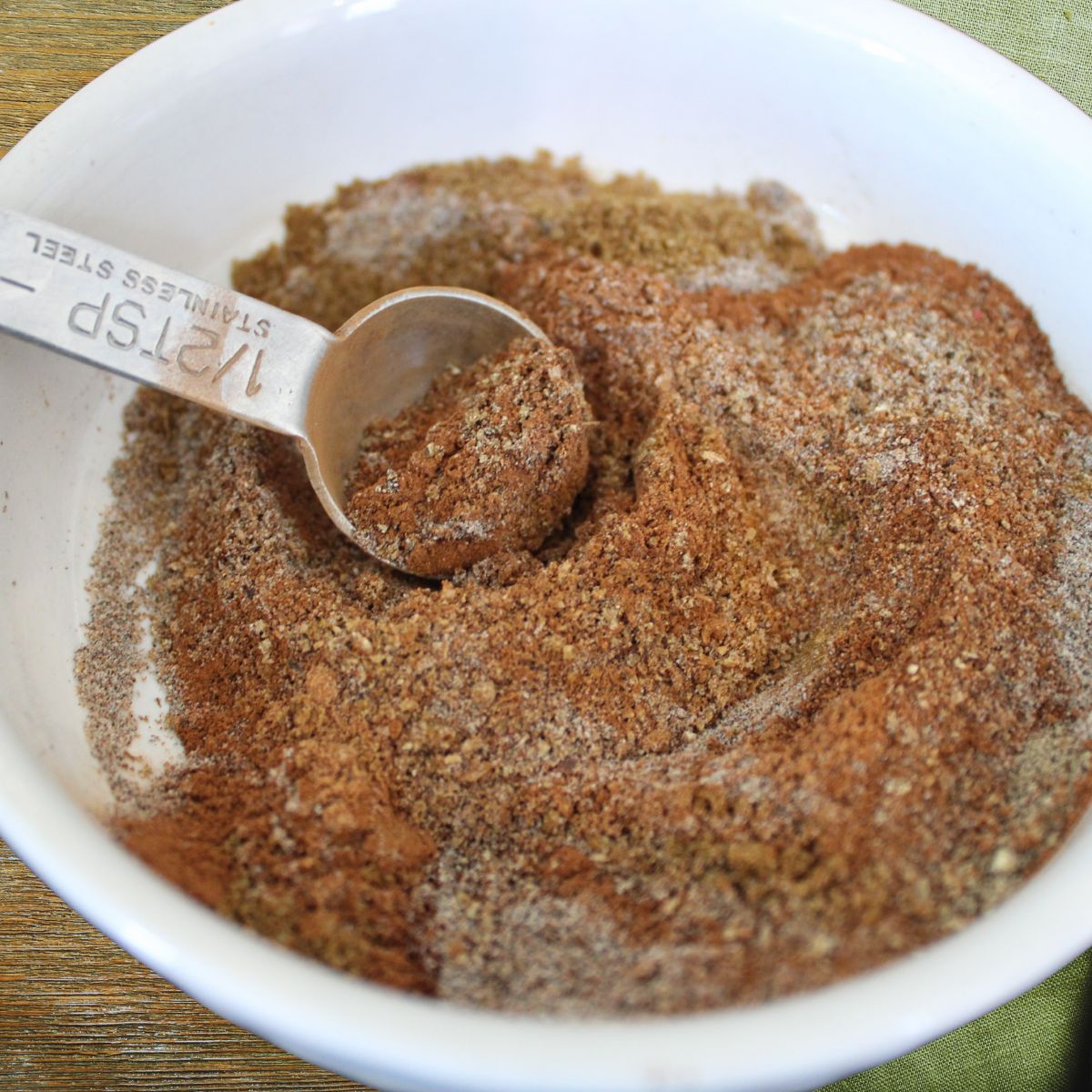 close up of garam masala spice mix in a small mixing bowl