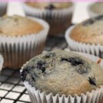 blueberry muffins on a wire cooling rack with a banner over it that says "Easy Sourdough Discard Blueberry Muffins"