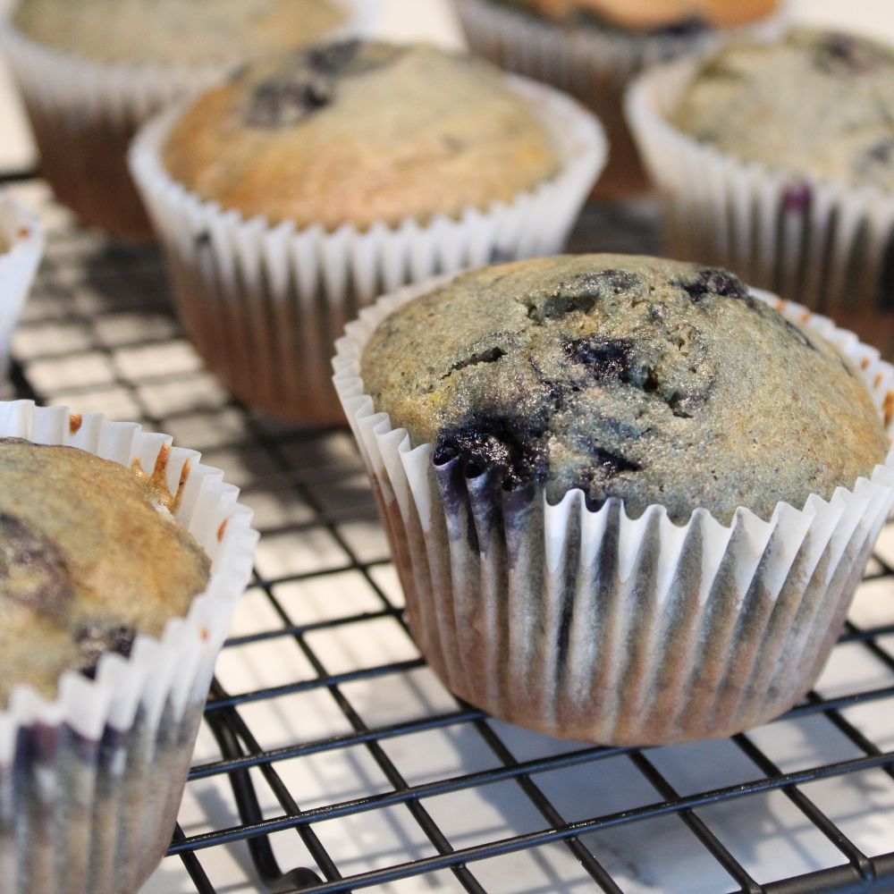 close up of blueberry muffins on a wire cooling rack