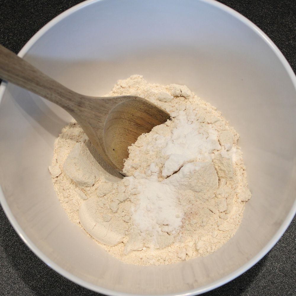 flour mixture in a bowl with a wooden spoon