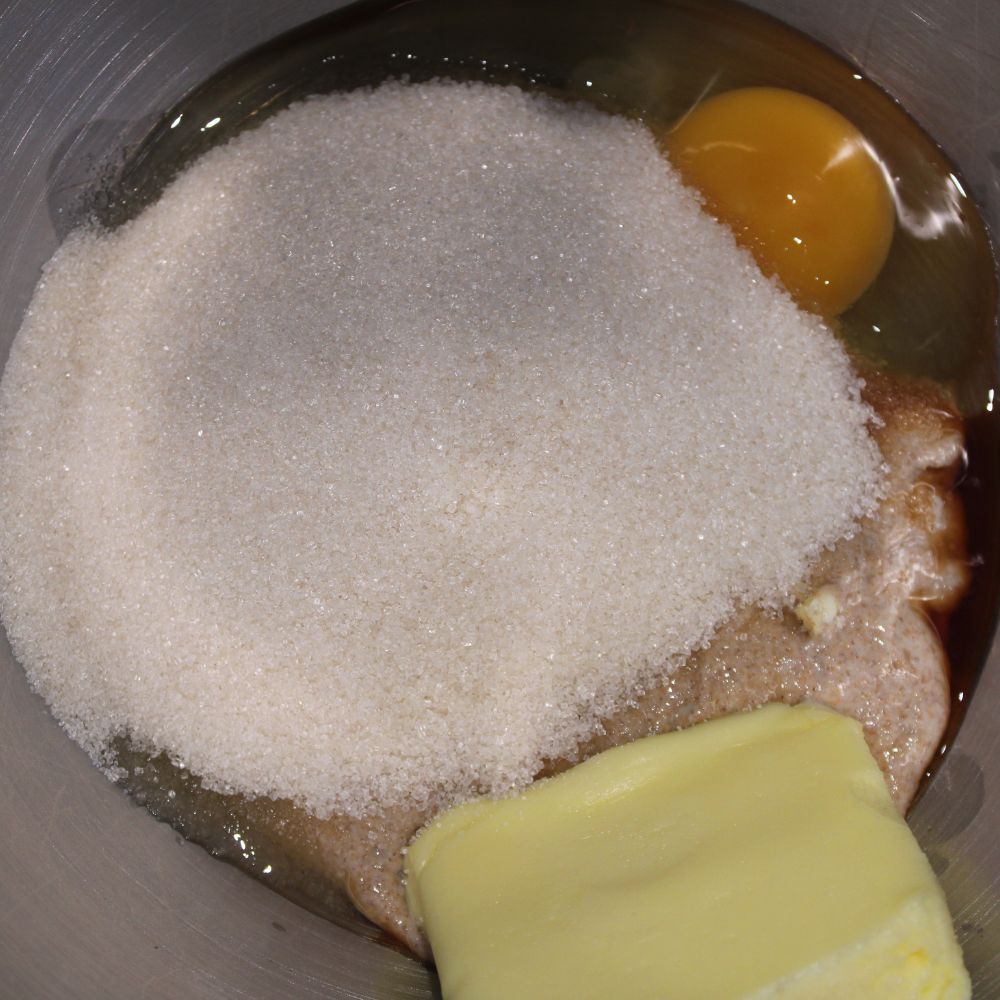 egg, sugar, butter, and sourdough discard in a mixing bowl, not yet mixed 