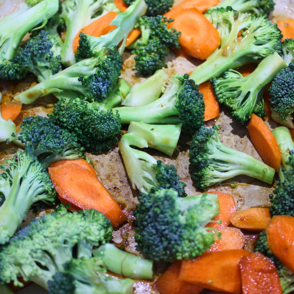 close up of broccoli and carrots in a frying pan