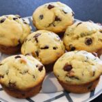 close up of homemade chocolate chip muffins on a plate