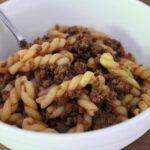 homemade hamburger helper in a bowl with a fork in it