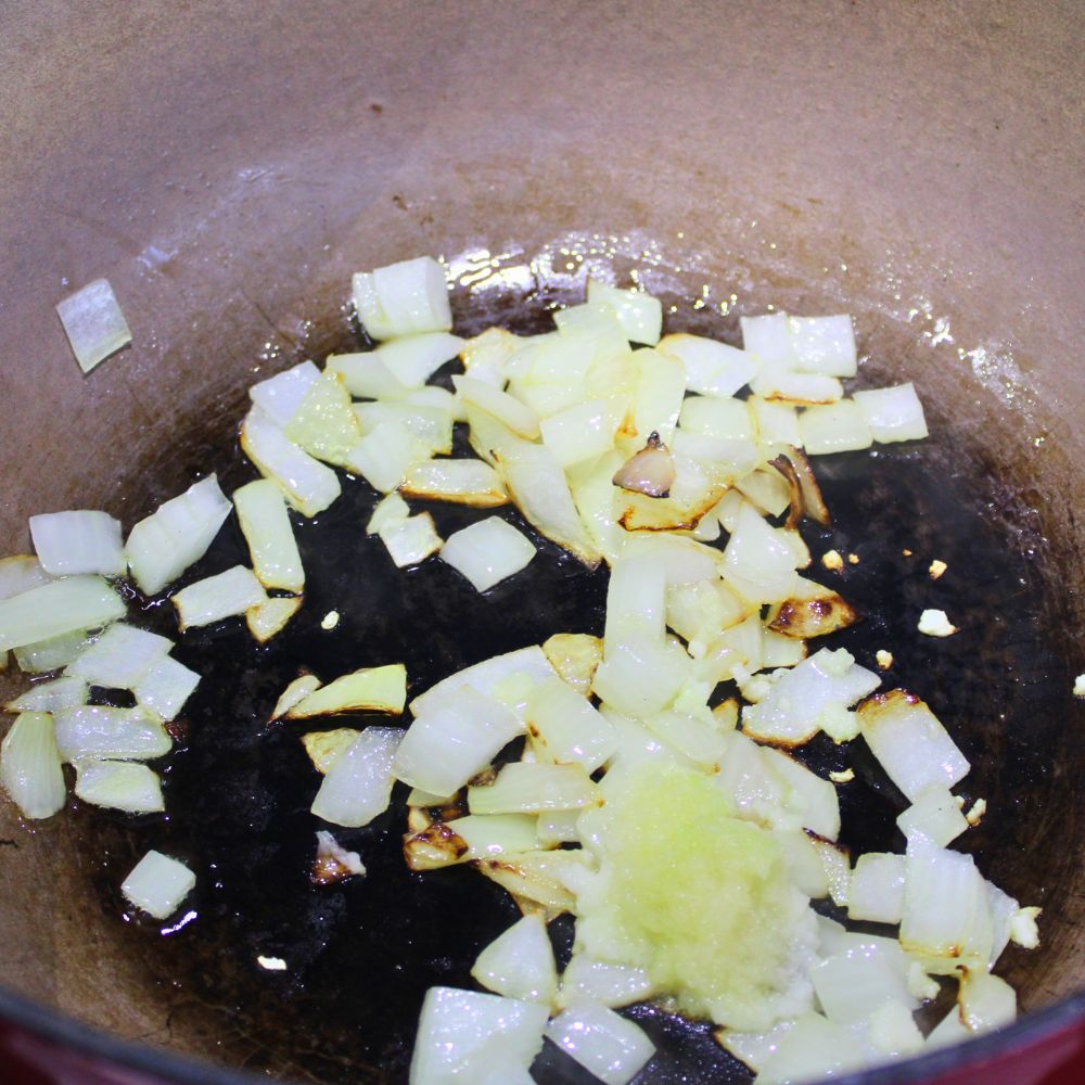 onions and garlic in a ceramic pot