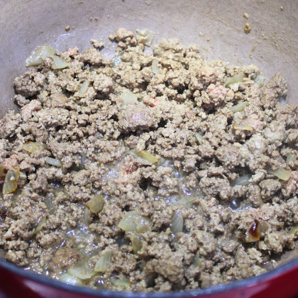 vooked ground beef in a cast iron pot