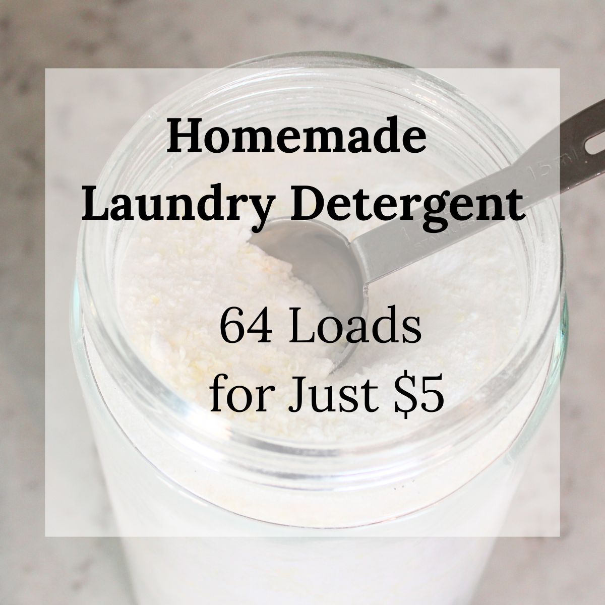 Overhead view of a glass jar filled with homemade powder laundry detergent, with a metal tablespoon scoop resting inside. Text overlay reads: "Homemade Laundry Detergent &ndash; 64 Loads for Just $5."